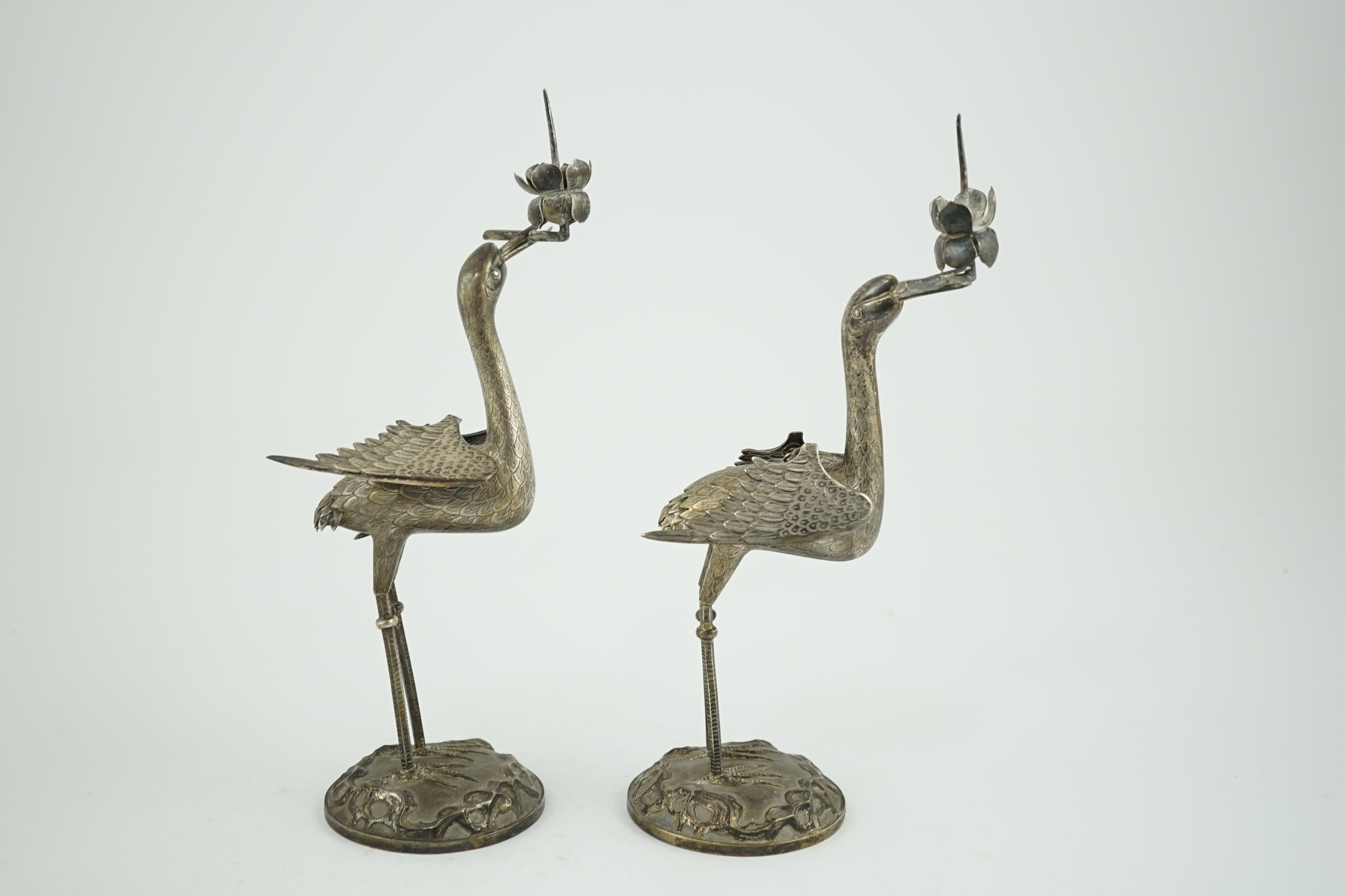 A pair of early to mid 20th century Japanese silver candlesticks, modelled as cranes